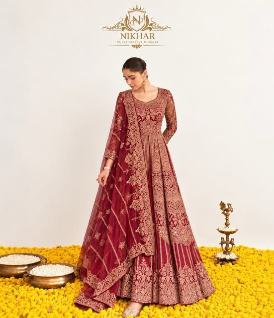 Maroon zari anarkali with brass diya on marigolds