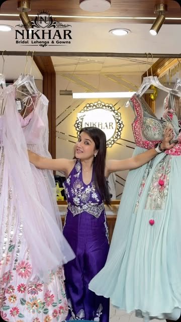 Inside the Nikhar showroom: a customer browsing pastel and purple gowns